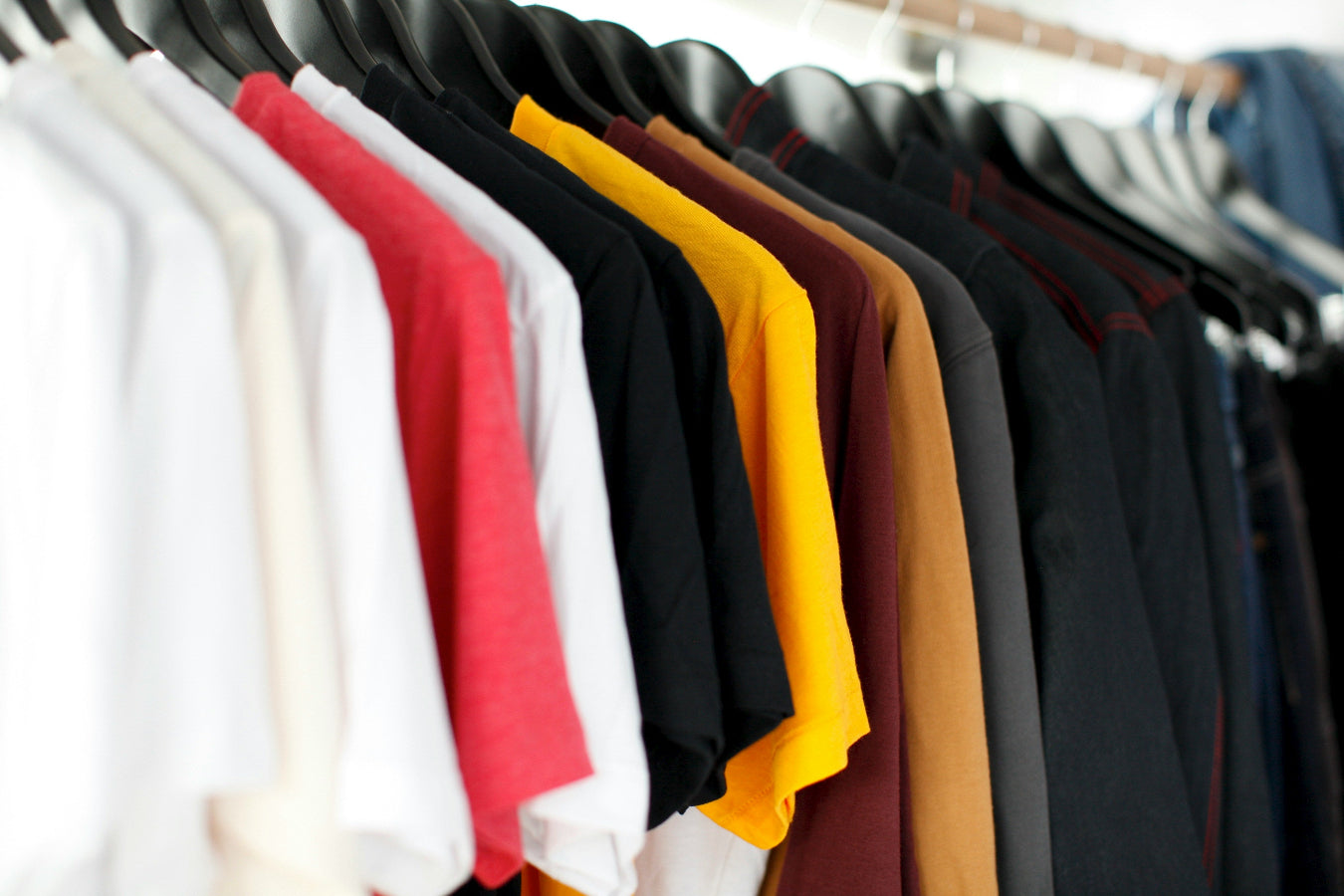 A rack of t-shirts in different colours