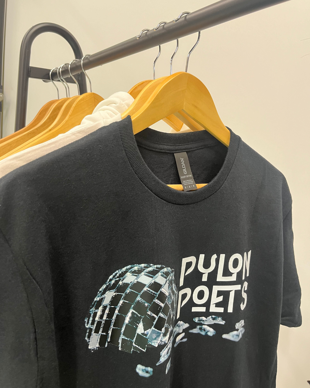 A printed white tee hanging outside